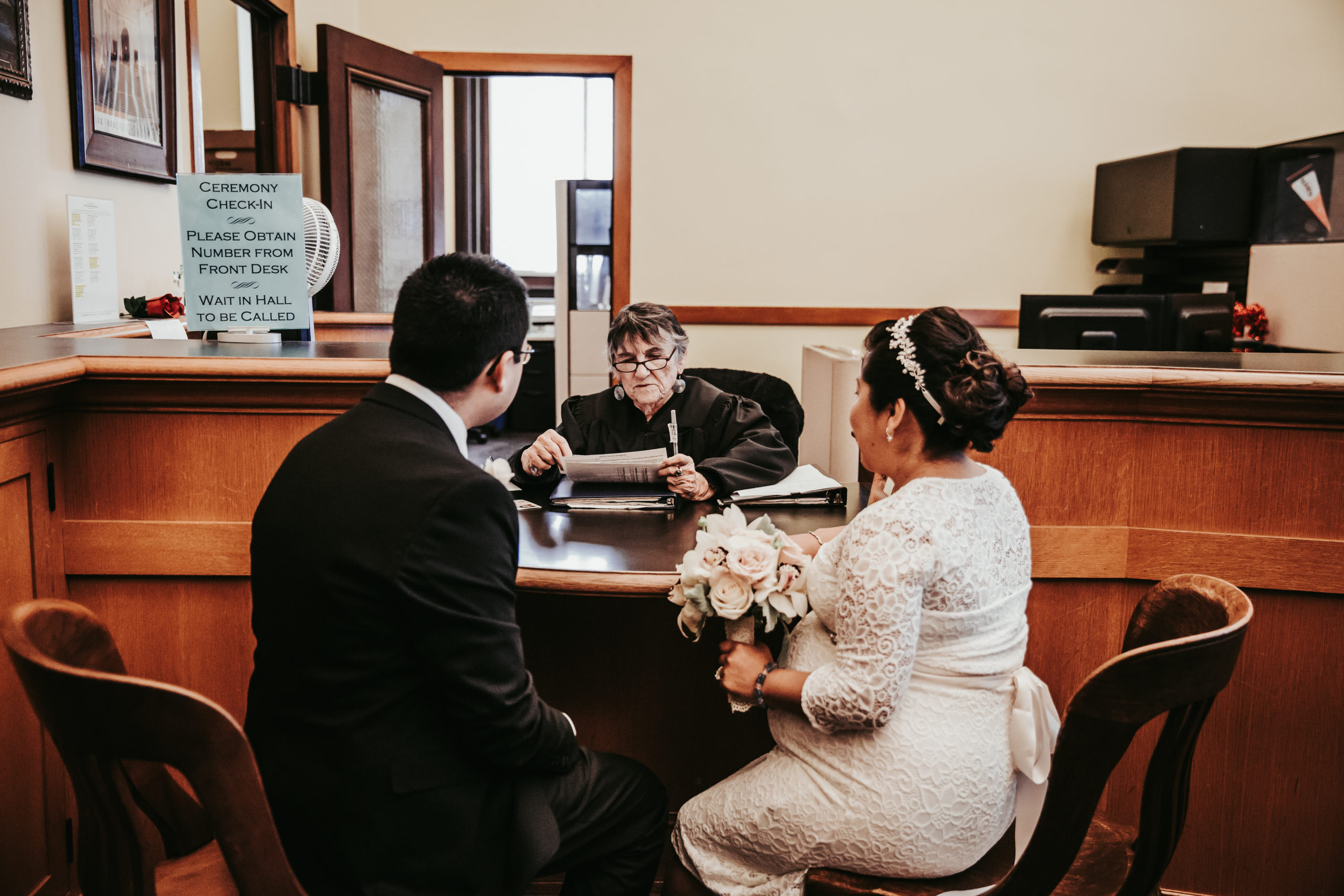 bride and groom meeting a justice of the peace for their City Hall wedding in San Francisco