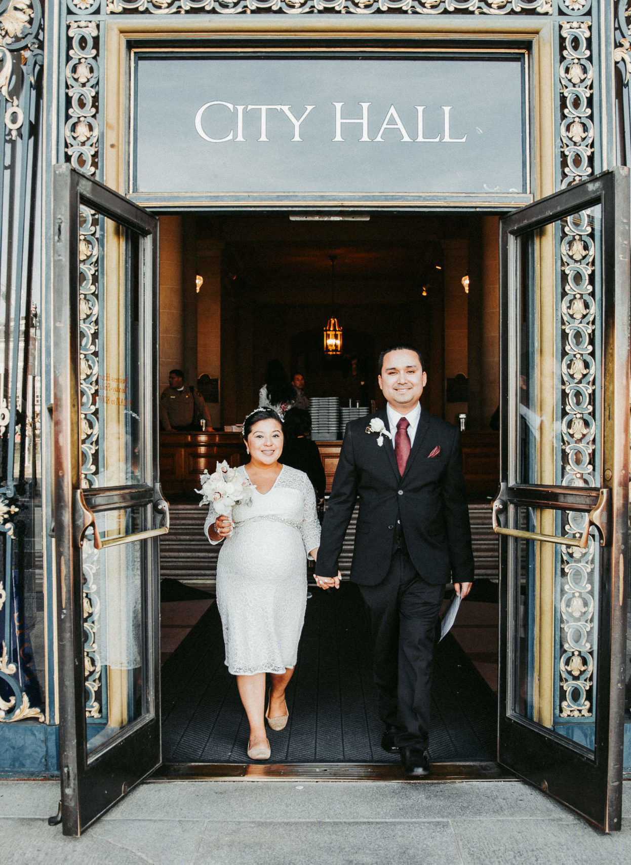 bride and groom exciting their City Hall wedding in San Francisco