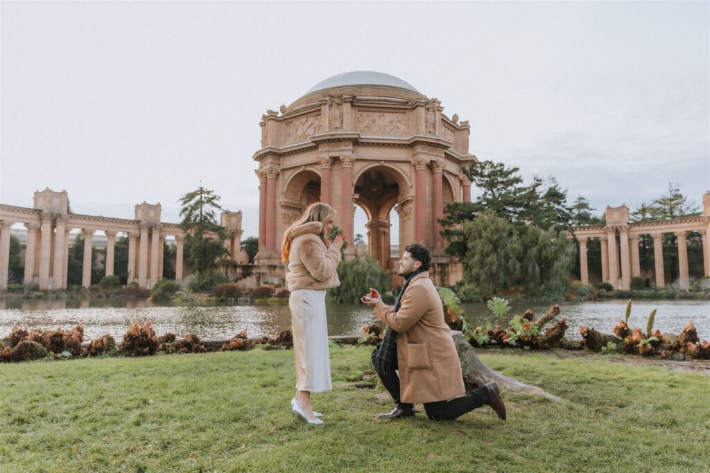 Romantic holiday proposal at the Palace of Fine Arts in San Francisco, featuring a happy couple in an iconic Bay Area setting.