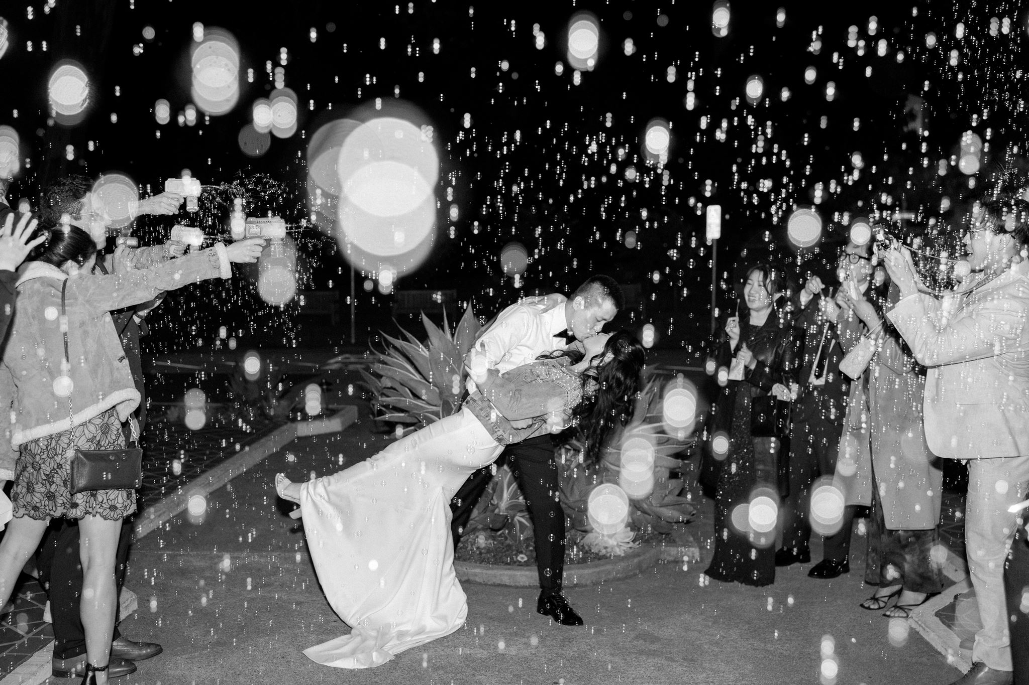 Newlyweds celebrating their grand exit with wedding guests at Golden Gate Club in San Francisco