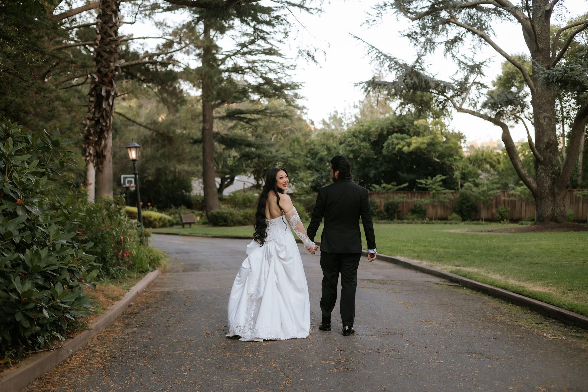 Newlyweds taking wedding portraits in the gardens at Hacienda de las Flores in Moraga