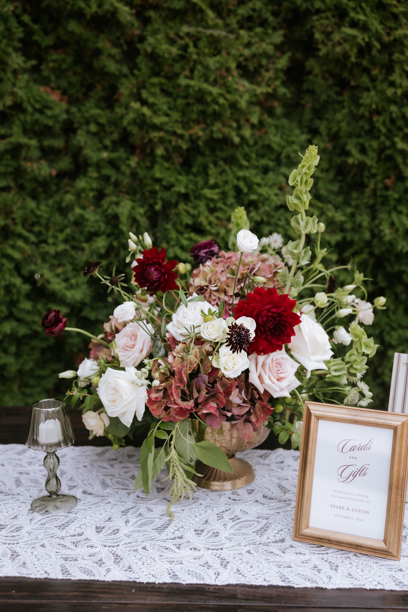 Burgundy and white wedding florals with greenery at Nella Terra Cellars