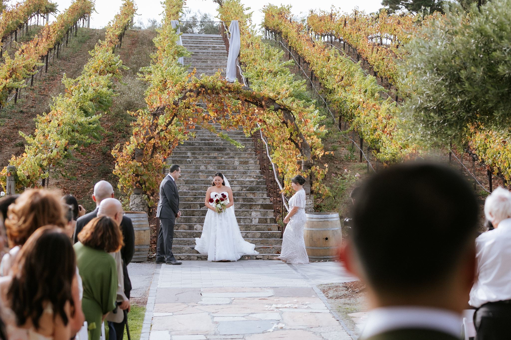 Bride entering the Ceremony with her parents at Nella Terra