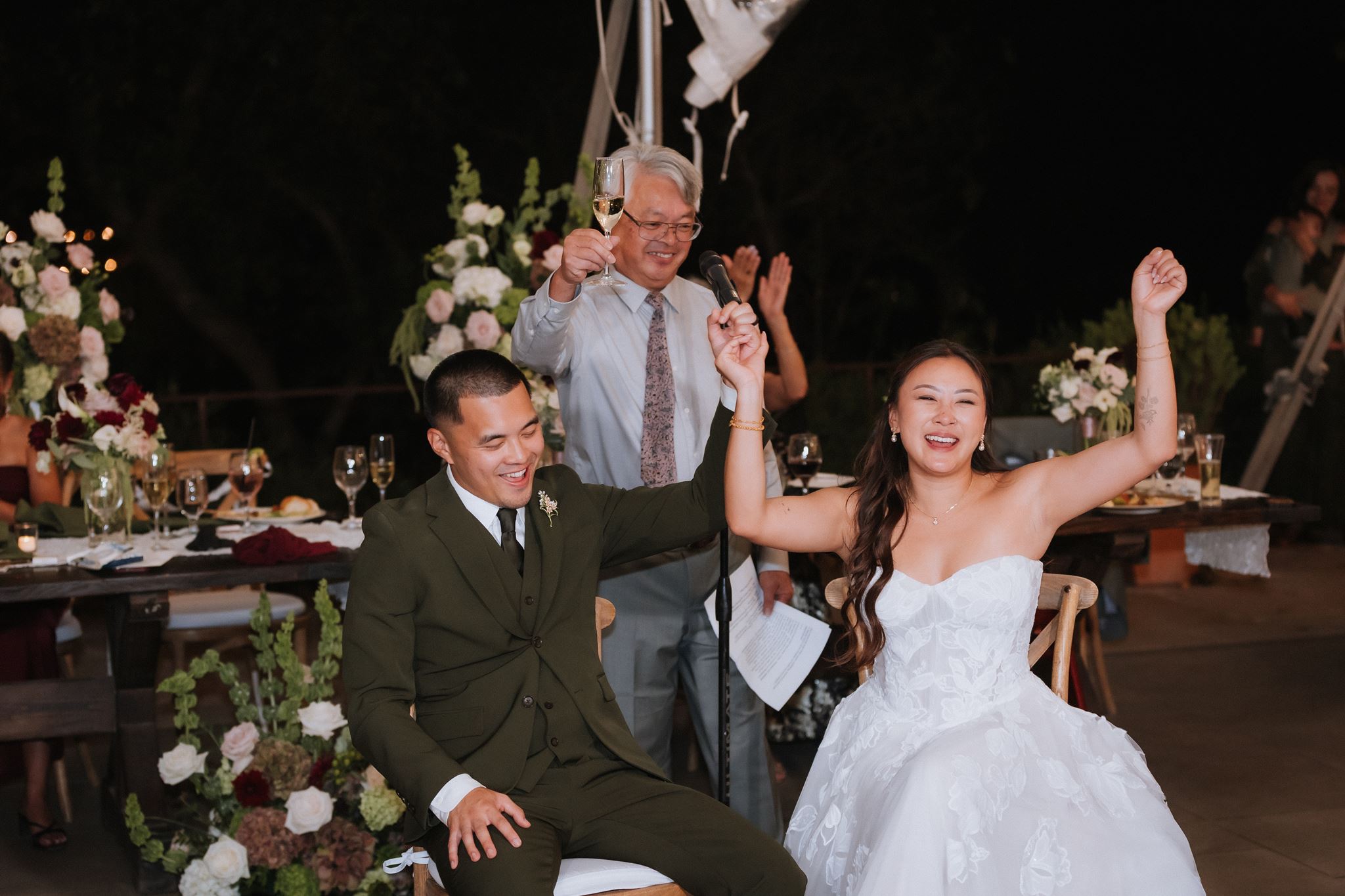 Newlyweds celebrating during wedding reception speeches
