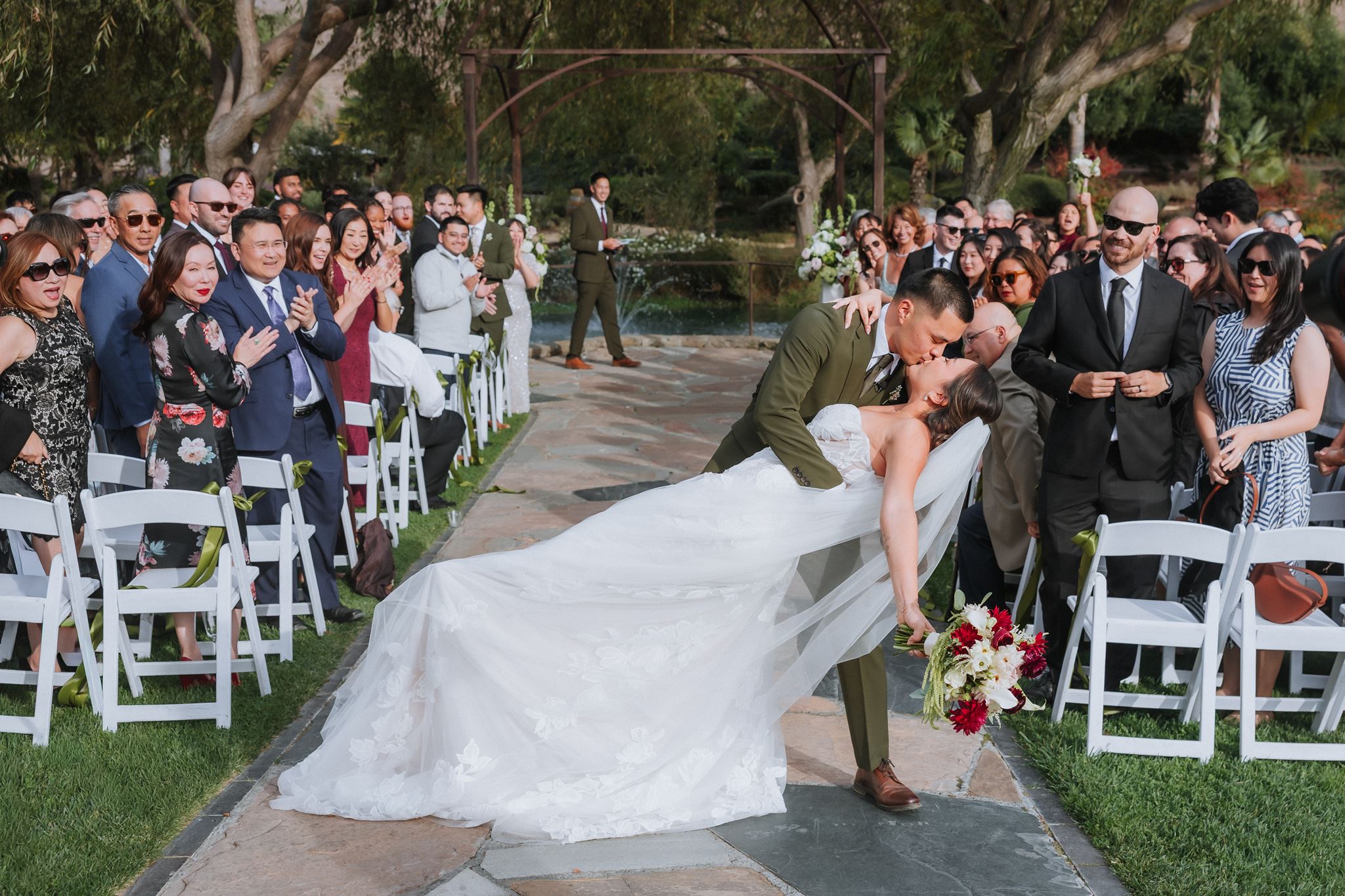 Couple dip and kiss at the end of the aisle after Ceremony at Nella Terra in Sunol