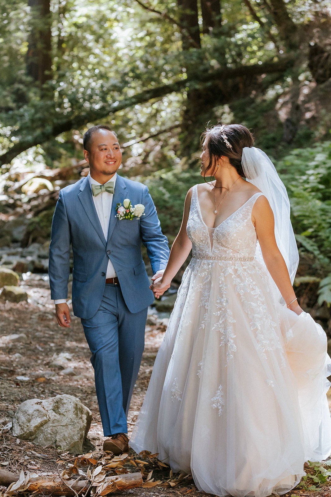 Newlyweds walking through the redwoods at Saratoga Springs